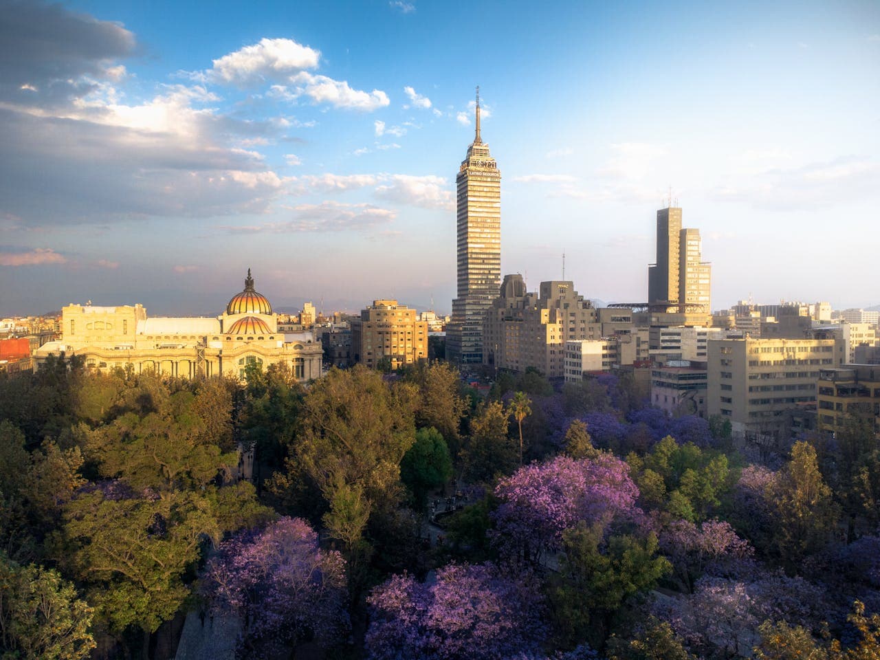 Drone shot of Mexico City, overseeing the Torre Lationo tower and the Palacio de Bellas Artes.
