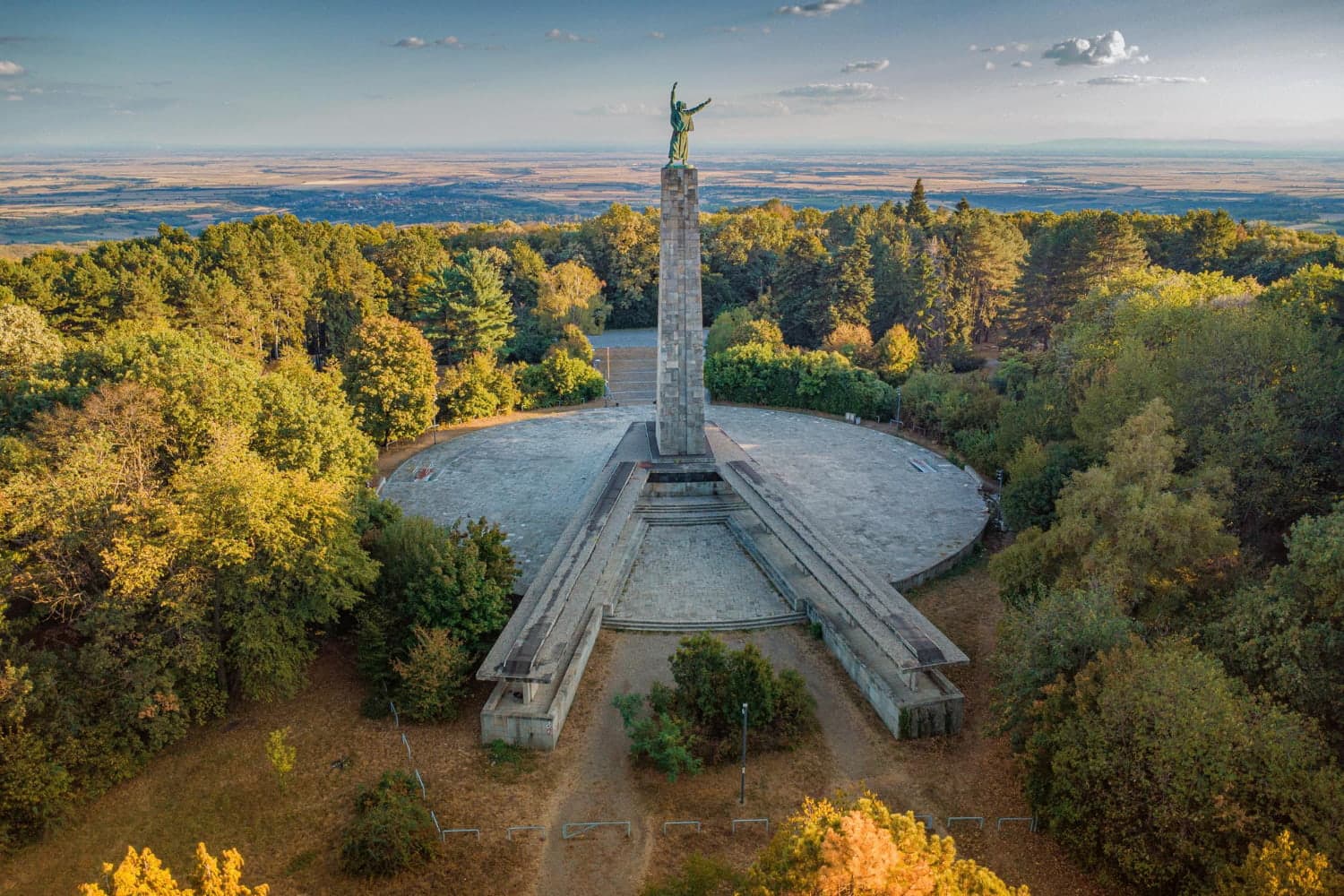 Aerial view of a Yugoslav-era war memorial monument surrounded by forest