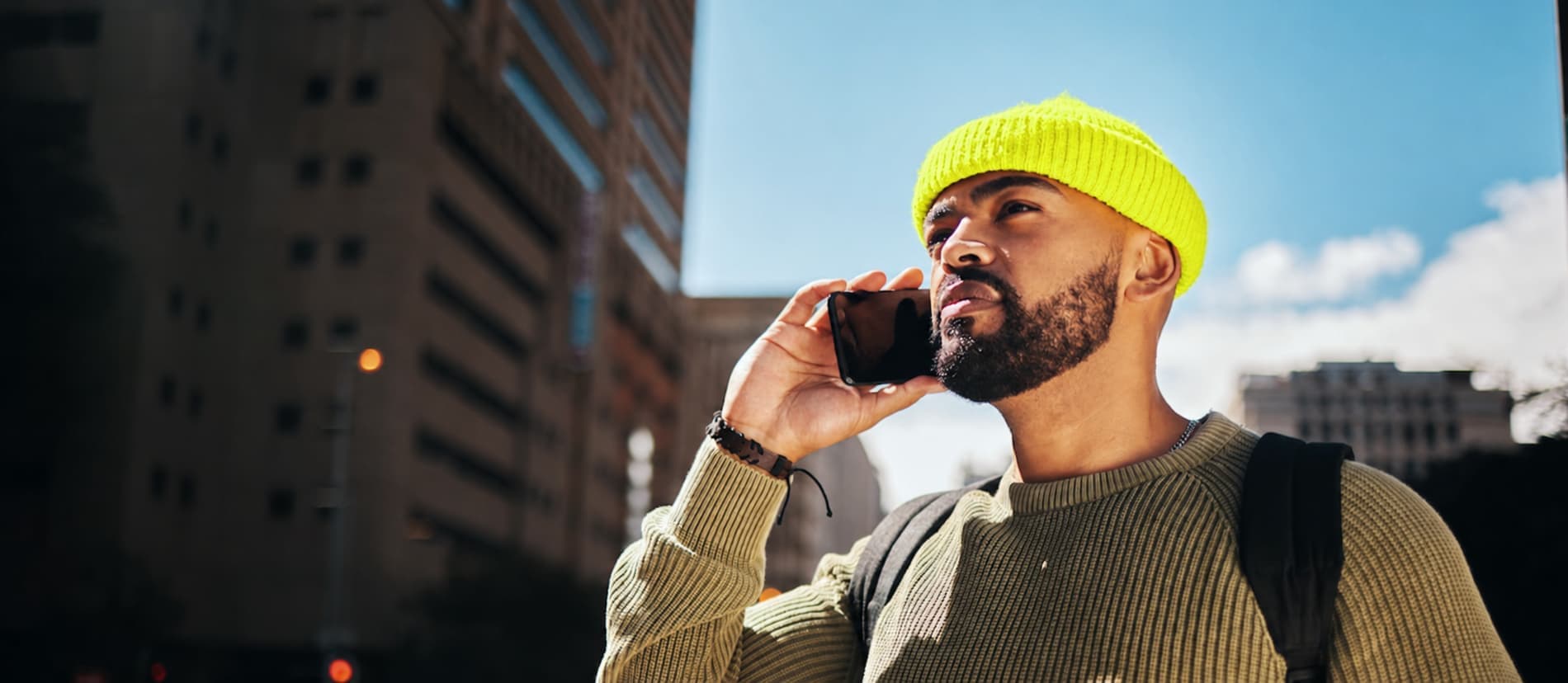 Man making an international call on his phone in the city