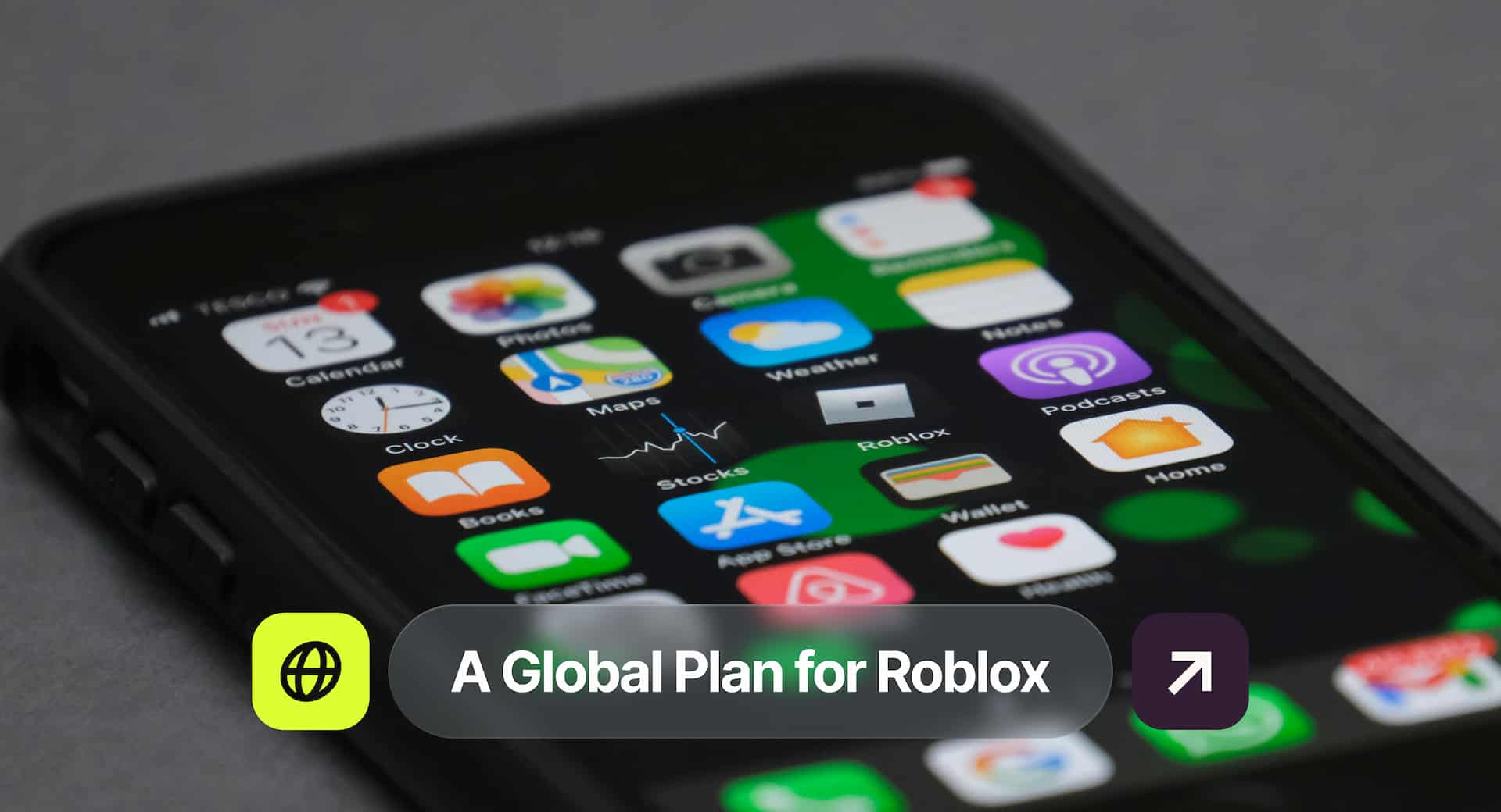 Close-up of a smartphone screen displaying various app icons, including Roblox. Text overlay reads, "A Global Plan for Roblox."