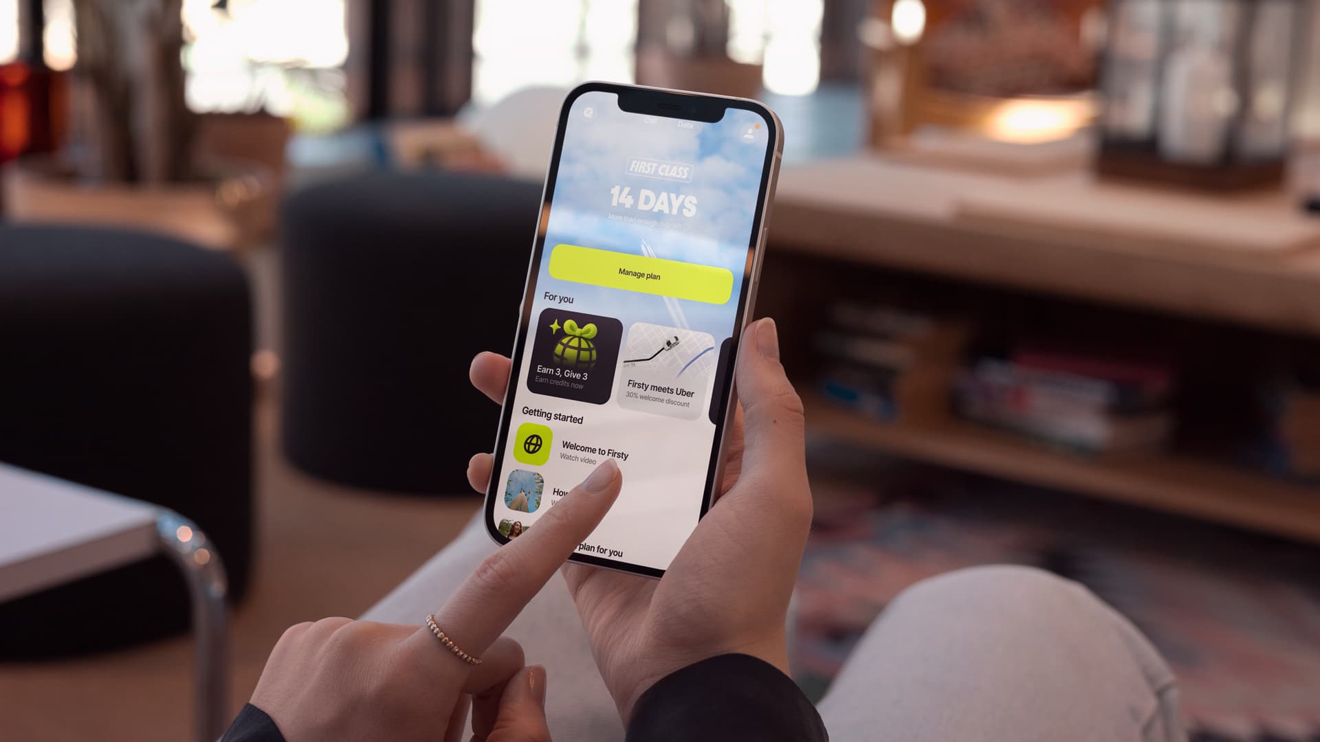 Firsty app home screen with a 14-day plan held on a phone