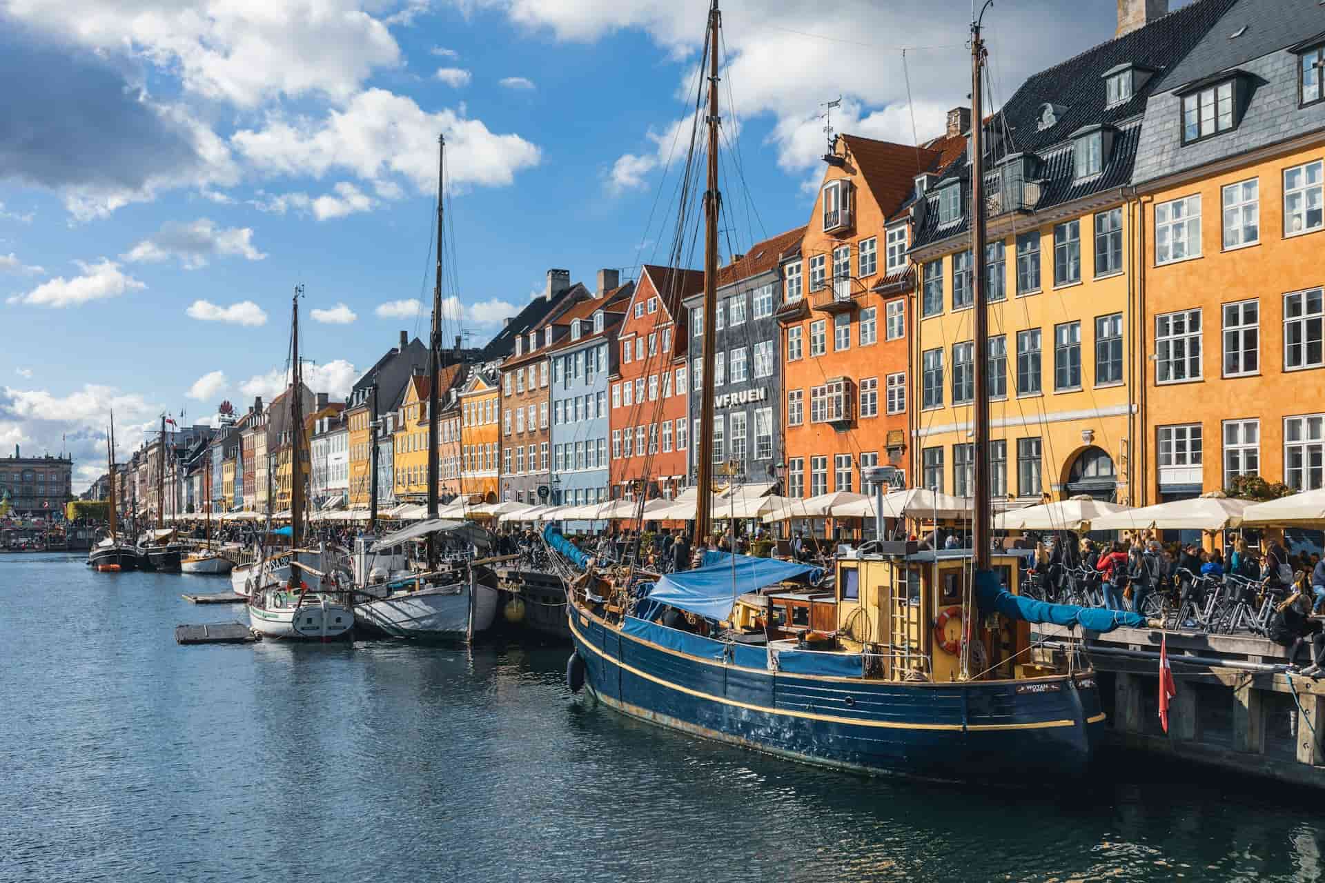 Colorful canal houses and boats along Nyhavn in Copenhagen, Denmark