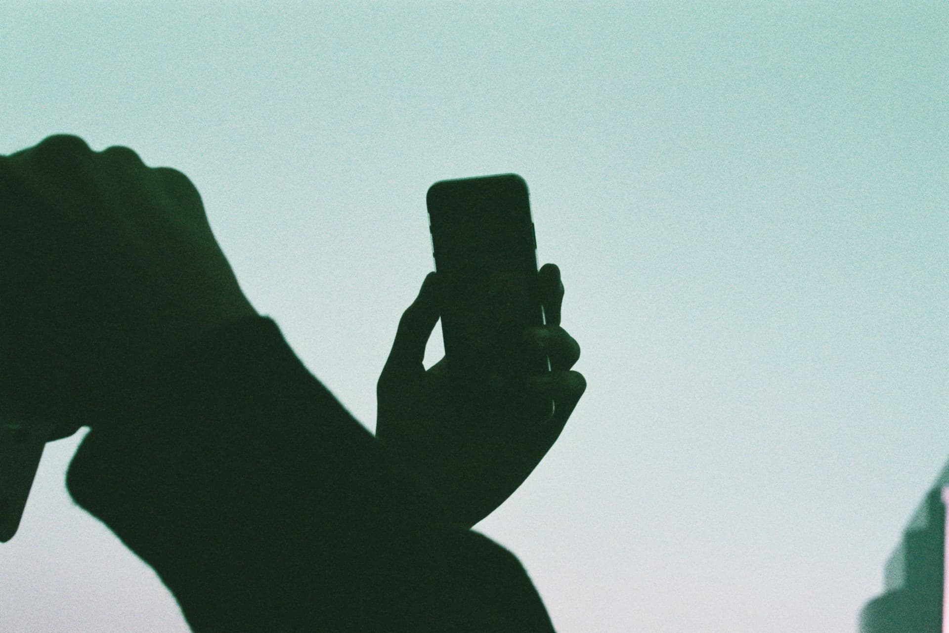 A person holding a smartphone, illustrating mobile data usage and fair use policy on a GSM plan in Belgium