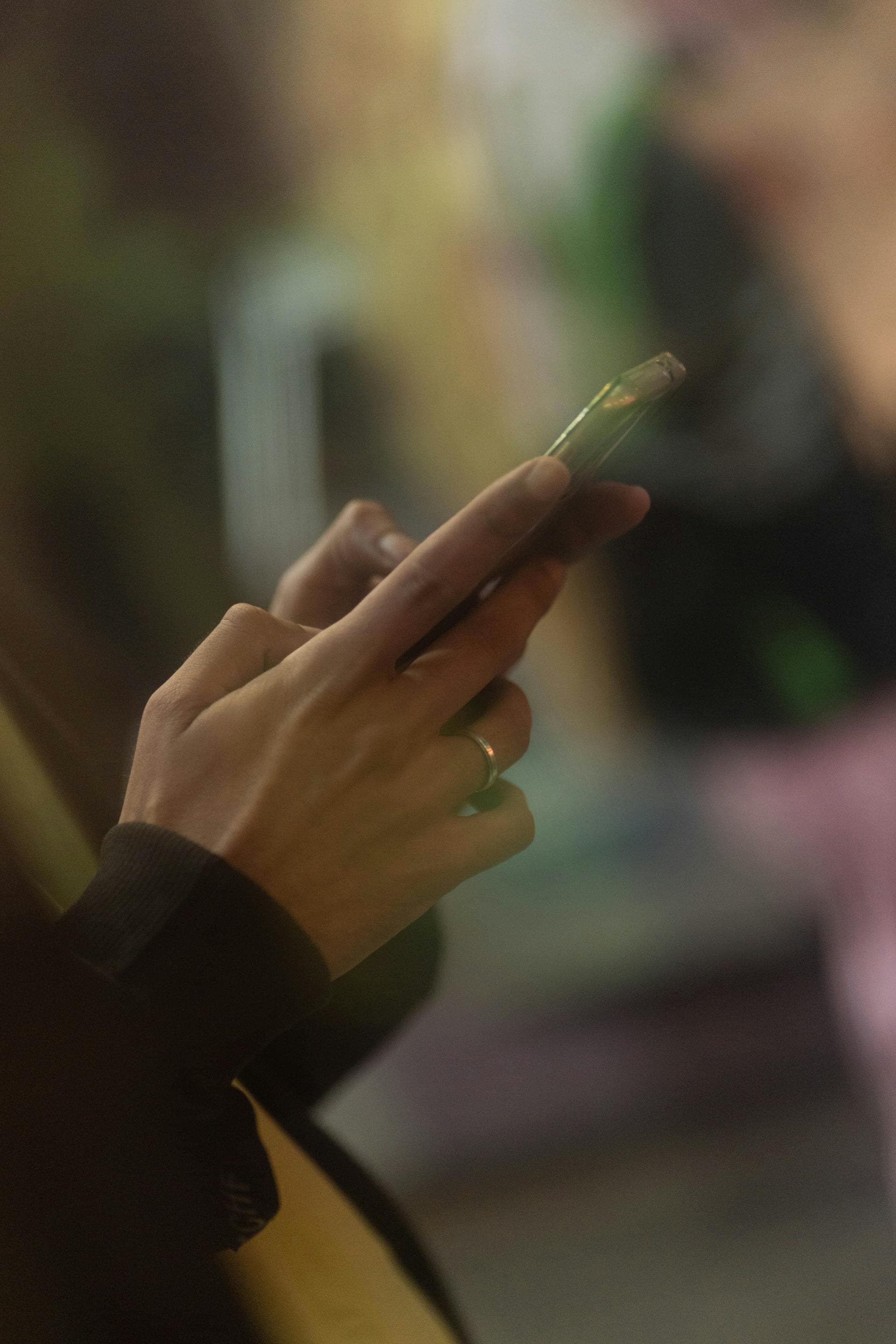 Close-up of a hand holding a phone at night