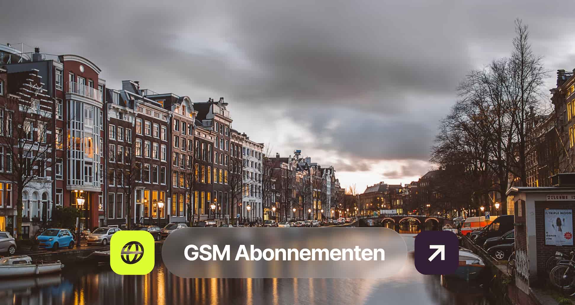 A canal lined with classic Dutch houses in Amsterdam at dusk with cars parked along the water and cloudy sky above.