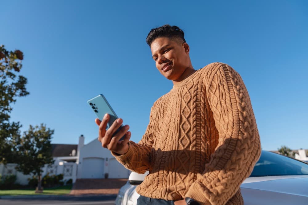 Man checking his phone outdoors