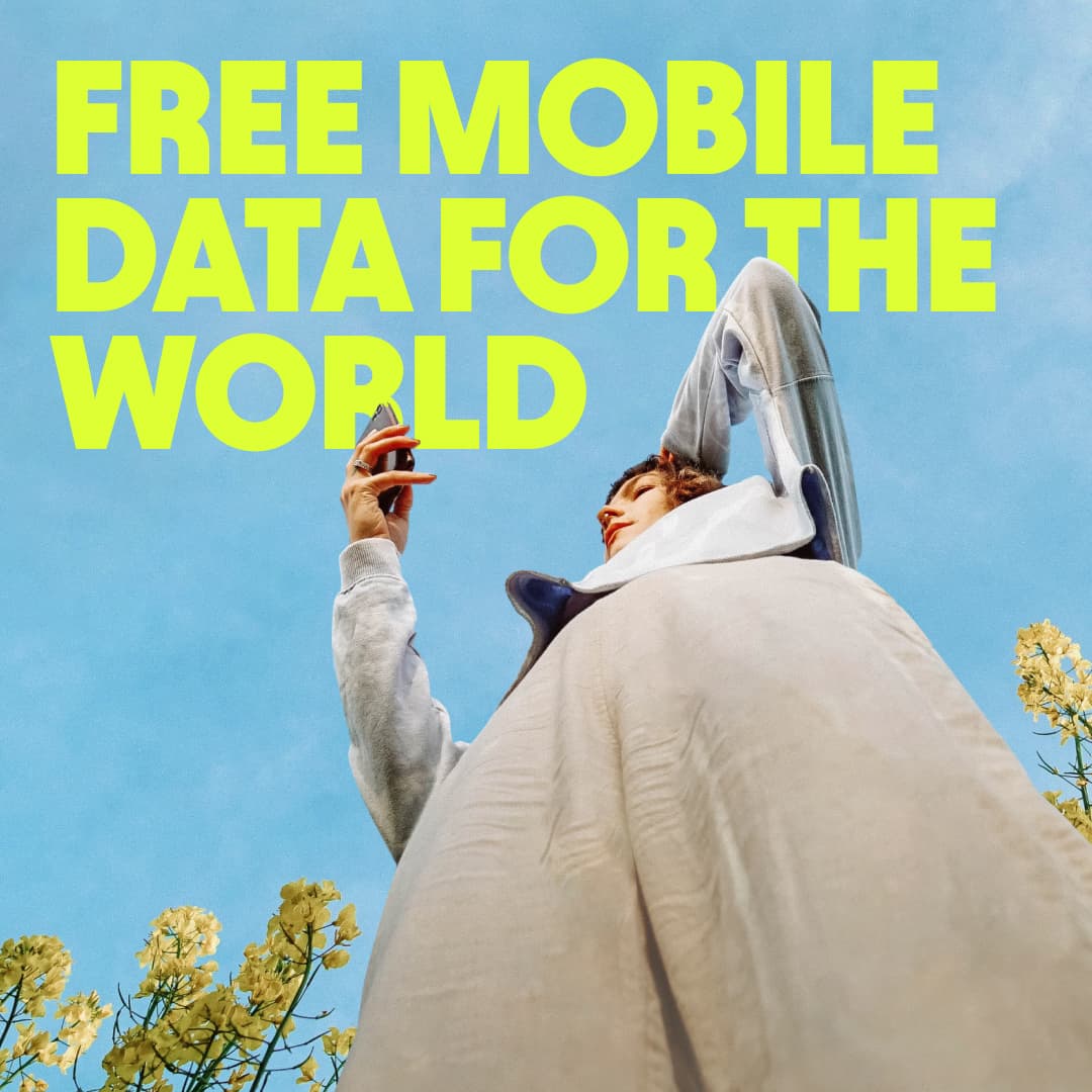 Firsty press release graphic reading Free mobile data for the world, with someone checking their phone outdoors