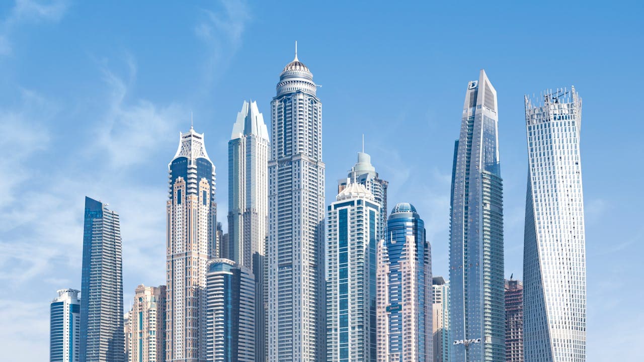 Dubai Marina's cluster of skyscrapers against a clear blue sky