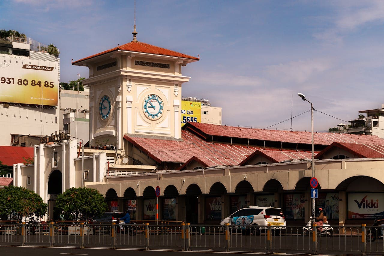 Front view of Ben Thanh Market with clock tower in Ho Chi Minh City, Vietnam, on a sunny day