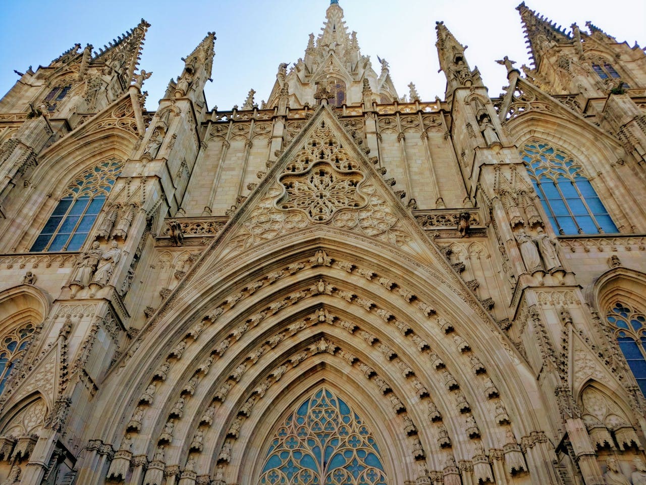 Gothic facade of the Barcelona Cathedral with intricate stone carvings and pointed arches