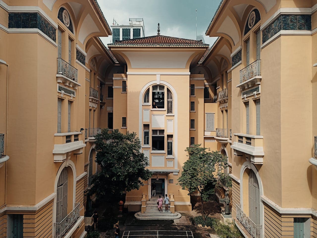 Elegant yellow French colonial architecture of the Ho Chi Minh City Museum of Fine Arts courtyard in Vietnam
