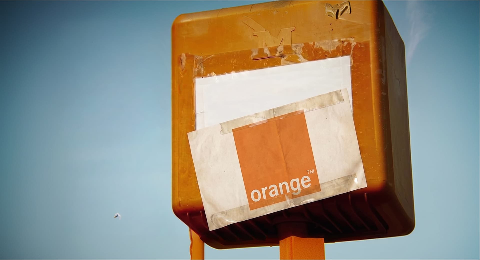 Orange telecom logo sticker on a postbox in Belgium