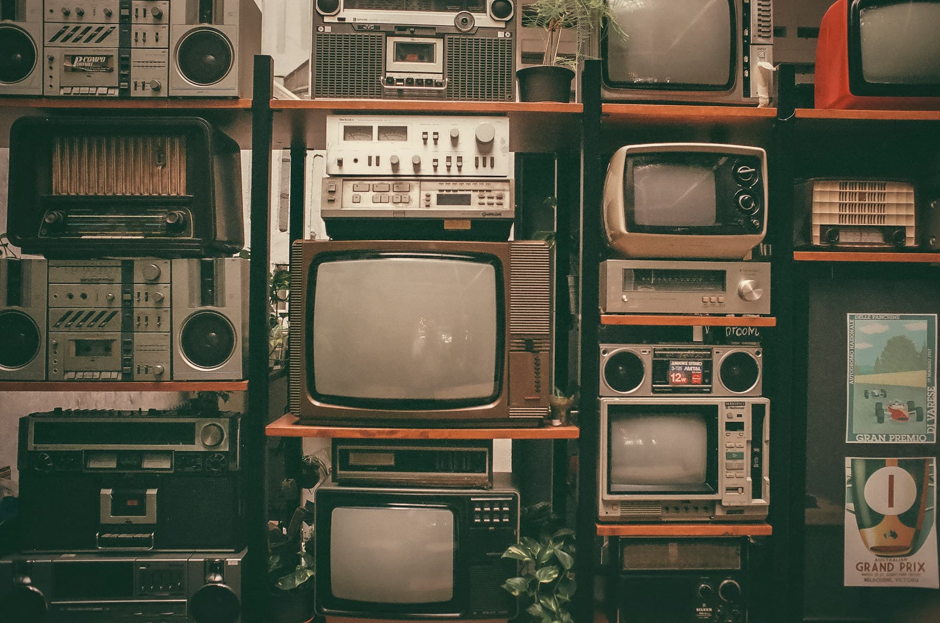 Shelves filled with vintage televisions and radios