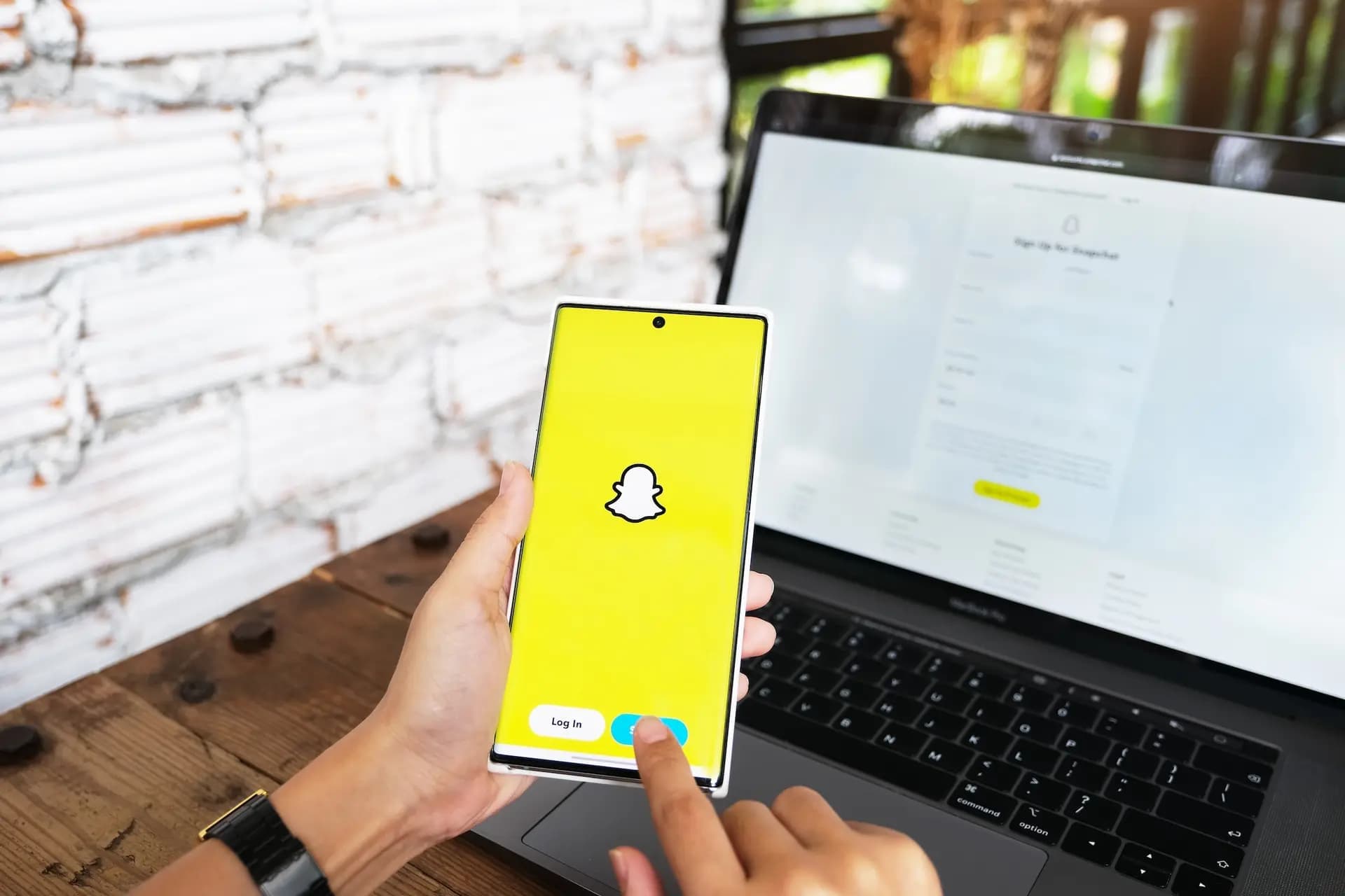 Hand using the Snapchat app on a phone over mobile data, illustrating everyday Snapchat data usage.