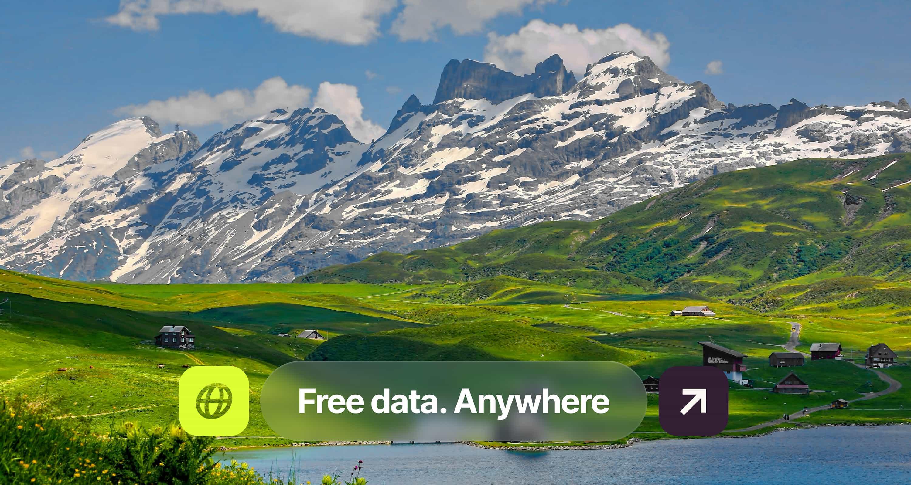 Snow-capped mountains, lush green hills with scattered houses, and a lake under a blue sky. Text overlay: "Free data. Anywhere."