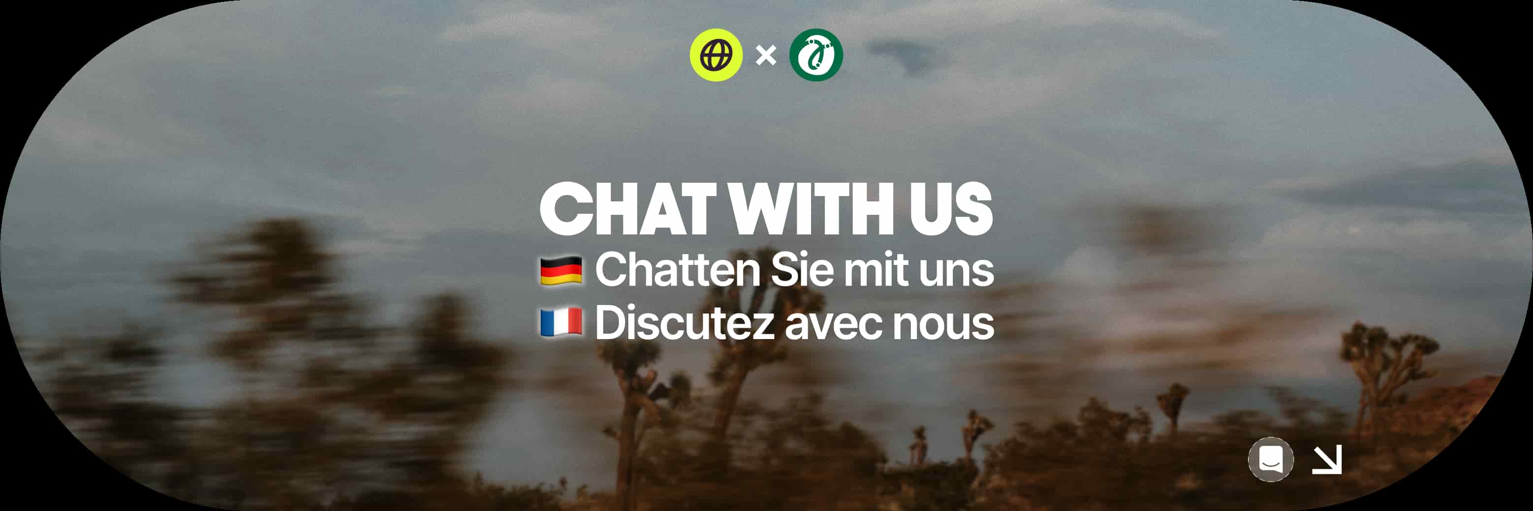 Blurry outdoor scene with "Chat With Us" text in English, German, and French, featuring German and French flags, and chat icons above.
