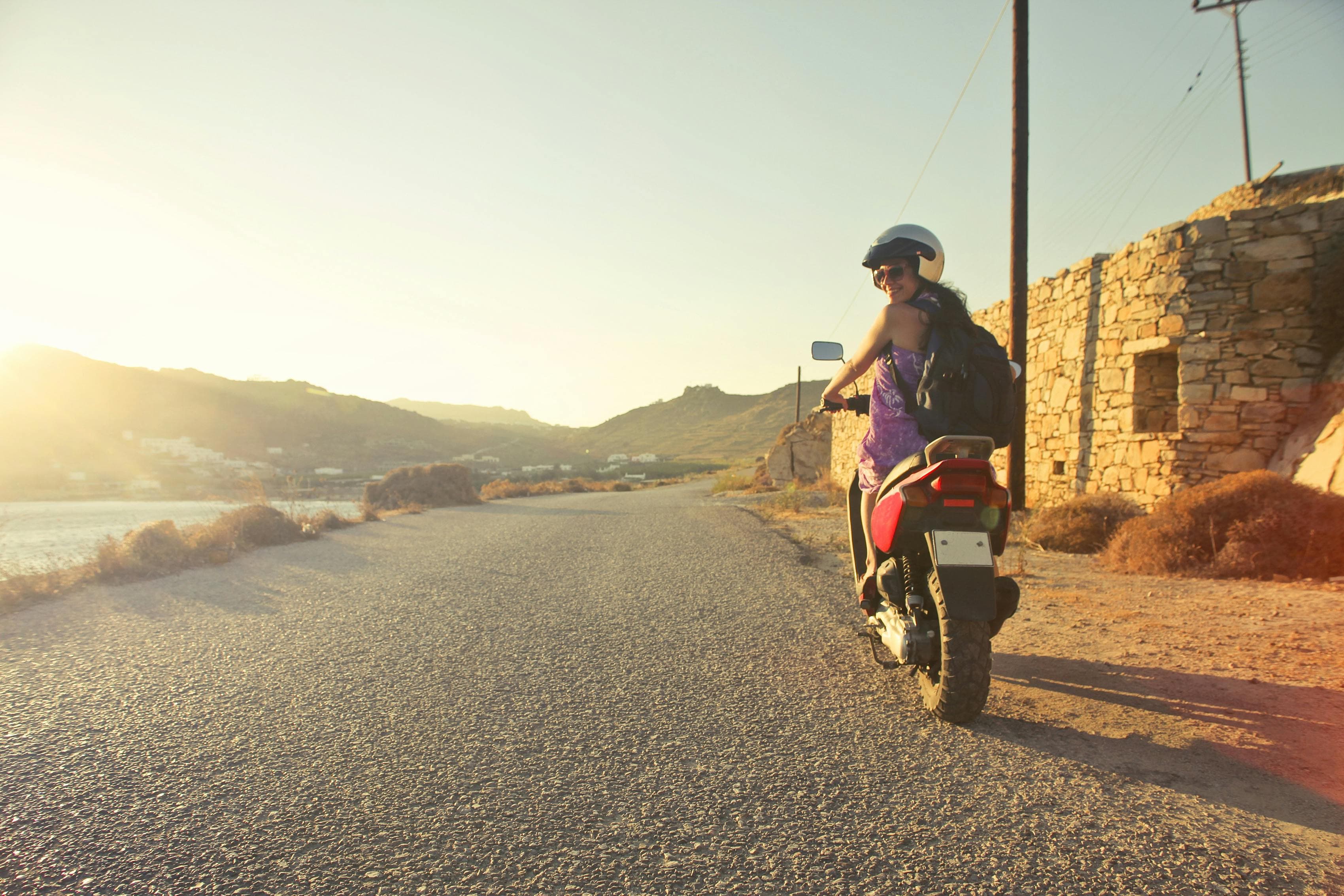 Traveler riding a scooter along a coastal road, for a guide on data roaming