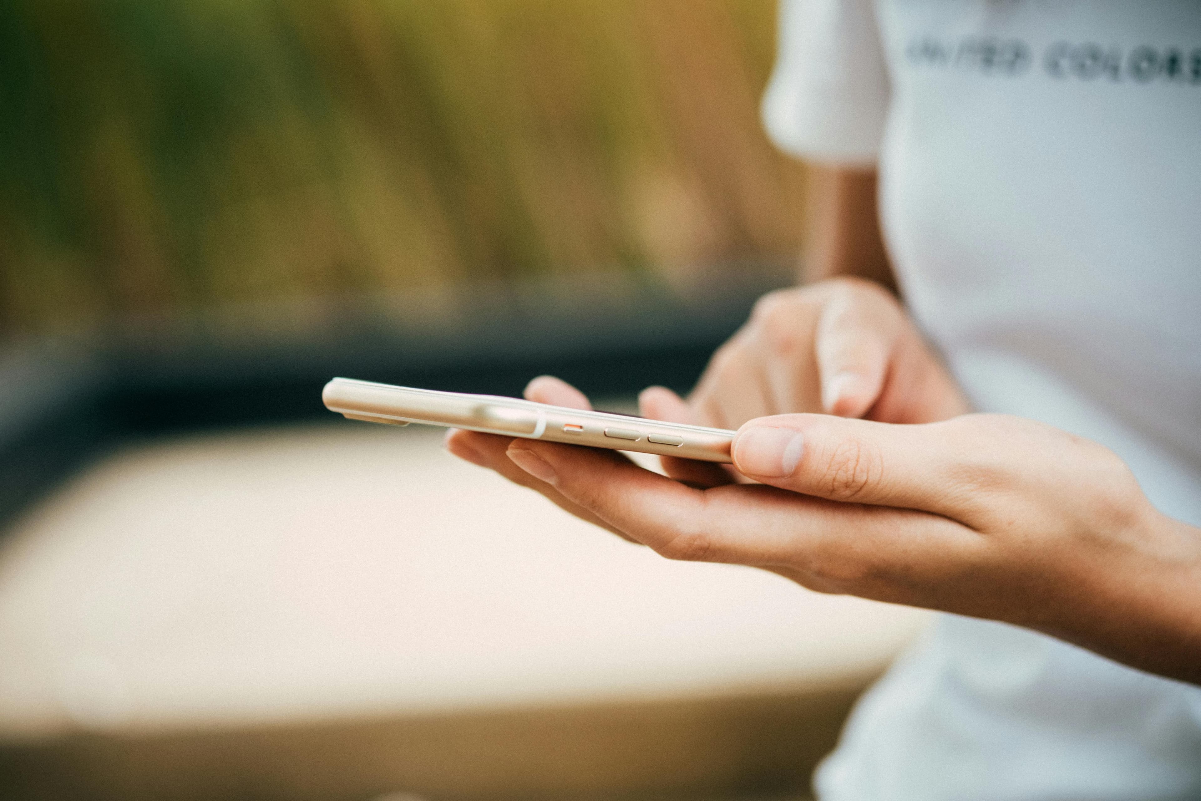 Person holding a smartphone to manage their mobile plan