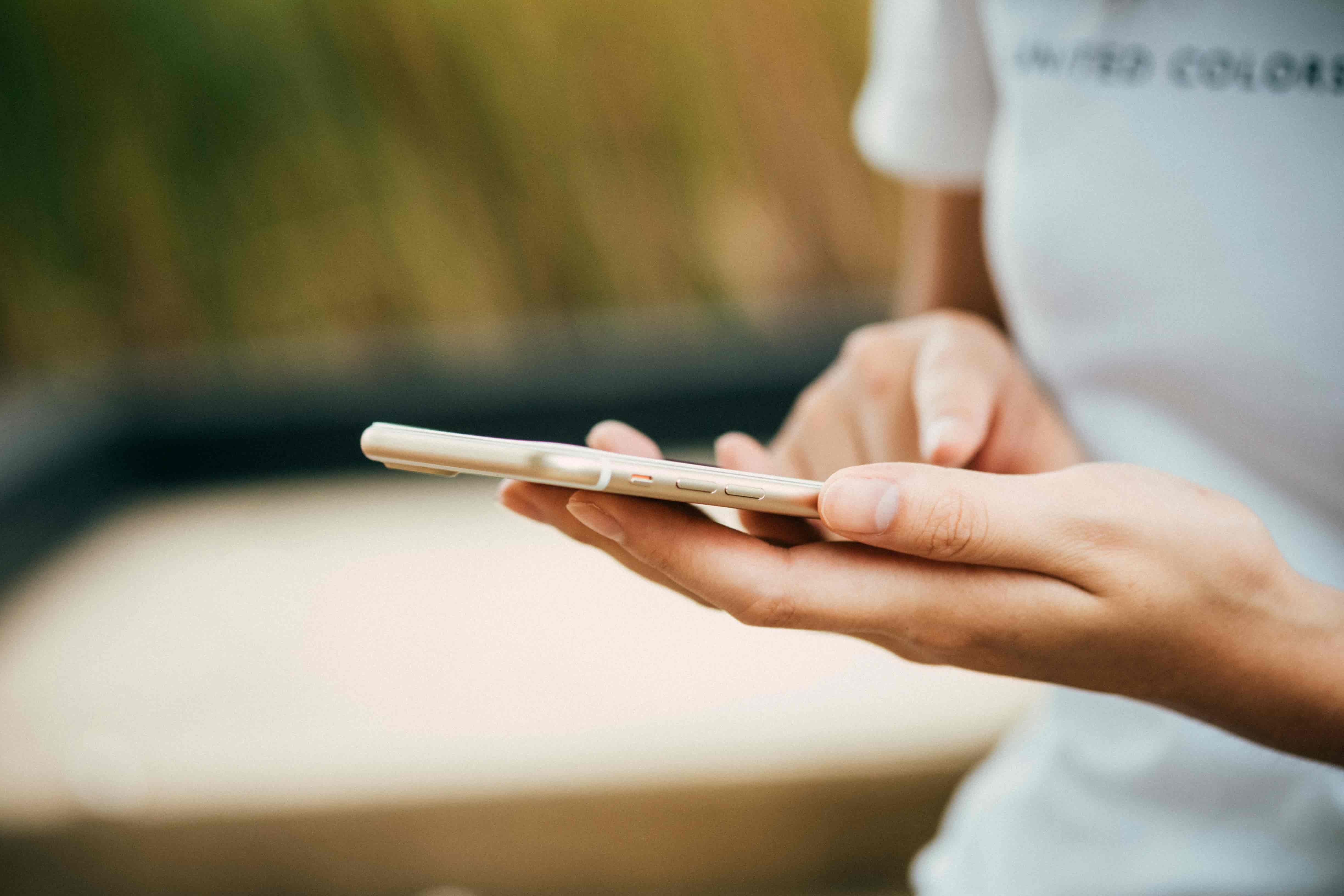 Person holding a smartphone to set up their eSIM