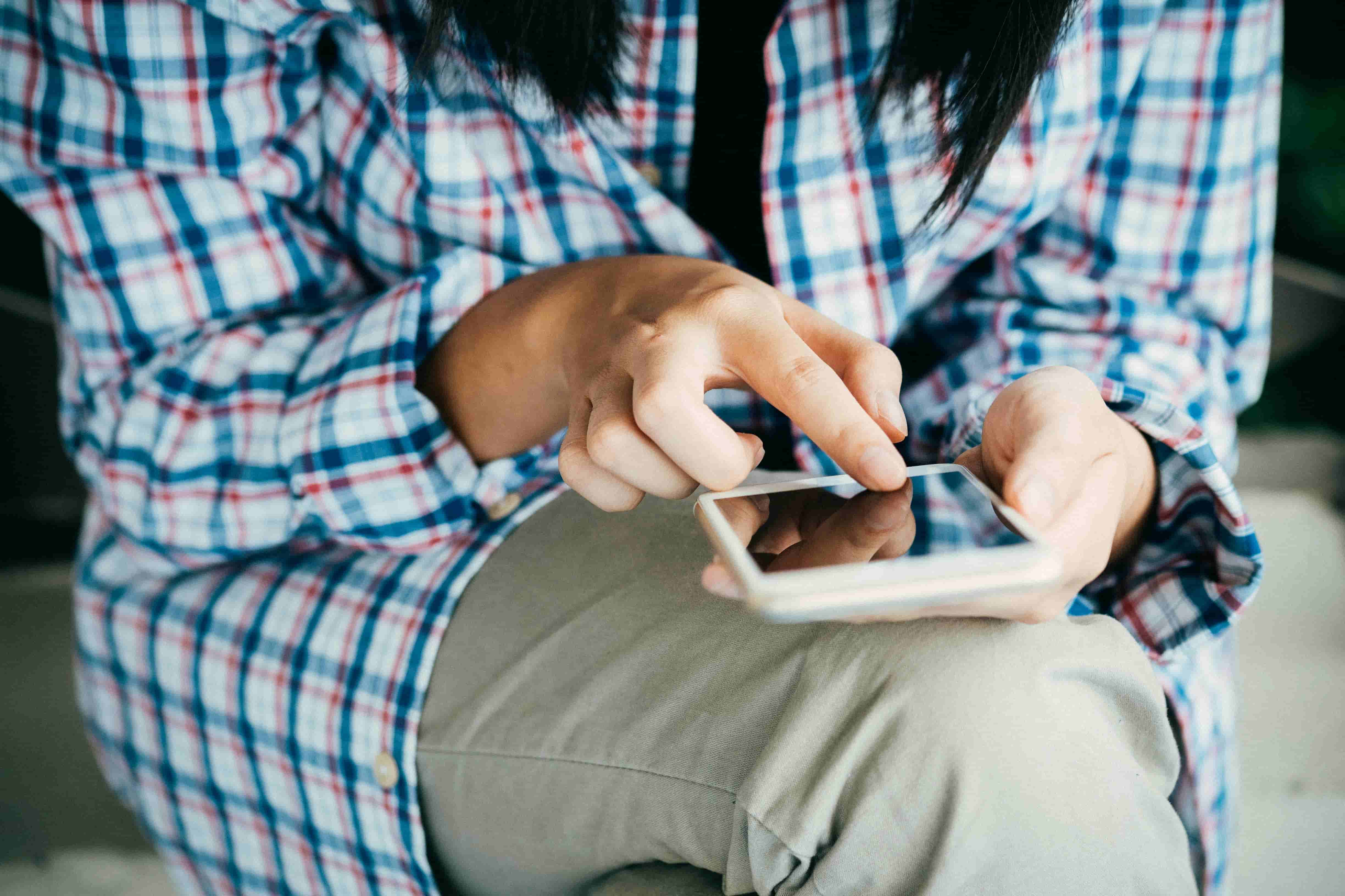 Hands holding and typing on a smartphone